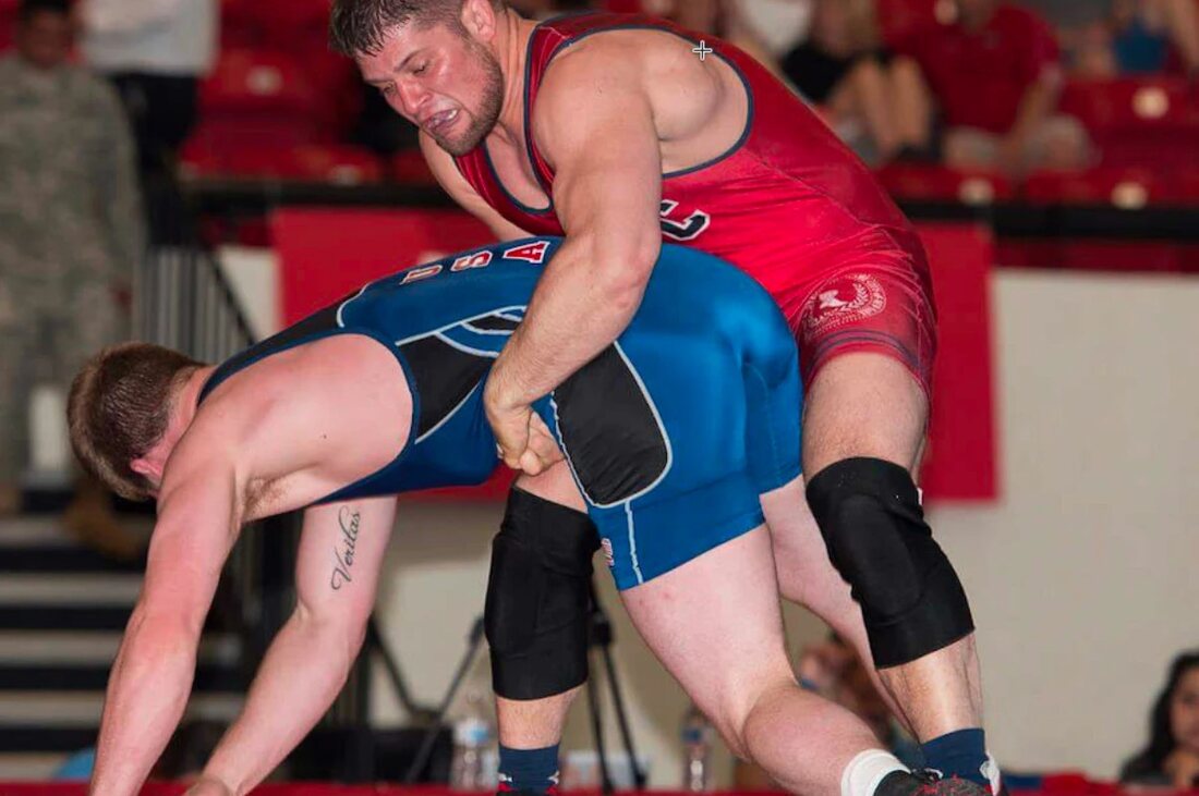 Orry Elor in a red USA singlet finishing a takedown in a Greco-Roman match